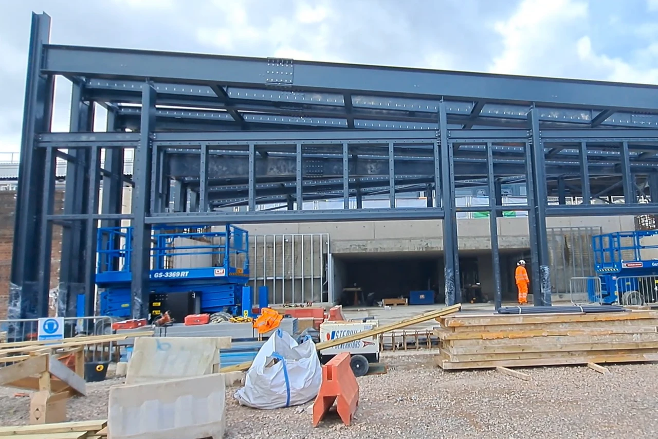 The steel frame shell of the building has been fully installed, standing 6 metres high and 20 metres wide in the Cattle Market Road compound, with the top visible from platform 15.