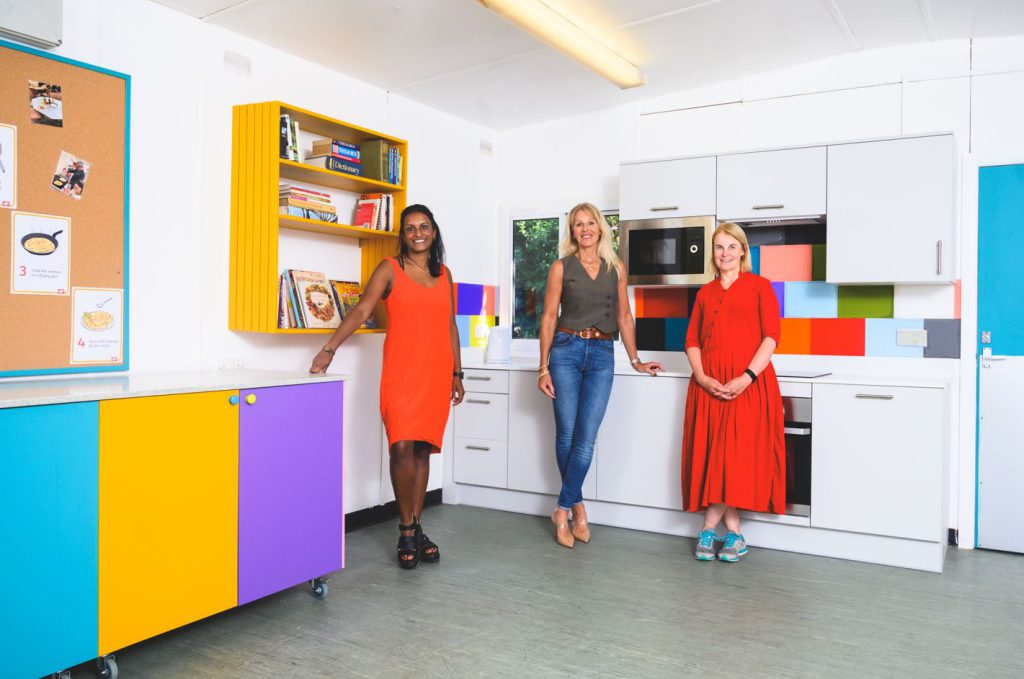 L-R Shanks Raj, Debra Hutt and Nola Hersey stand in the refurbished kitchen.