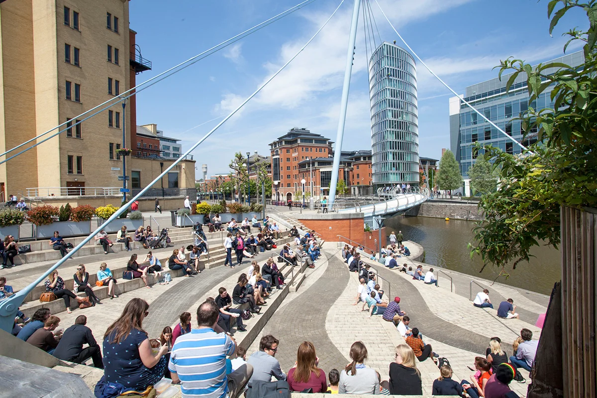 Photo of people sat on steps by the water at Temple Quay.